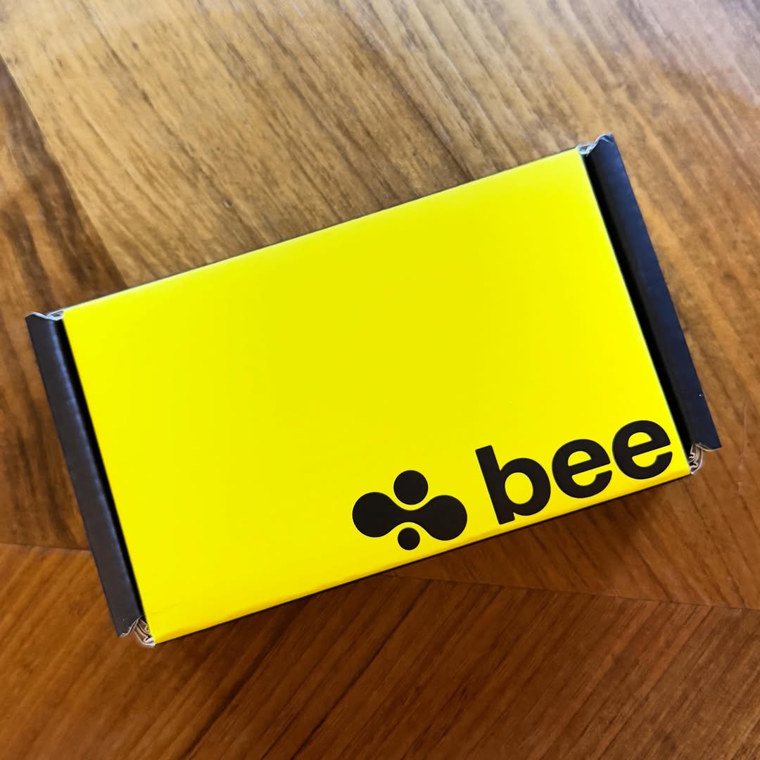 Bright yellow Bee wearable box on a wooden table