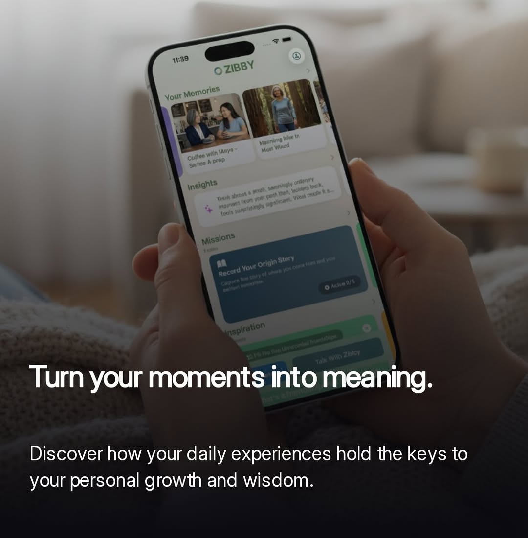 Hands holding a phone open to Zibby memories on a couch